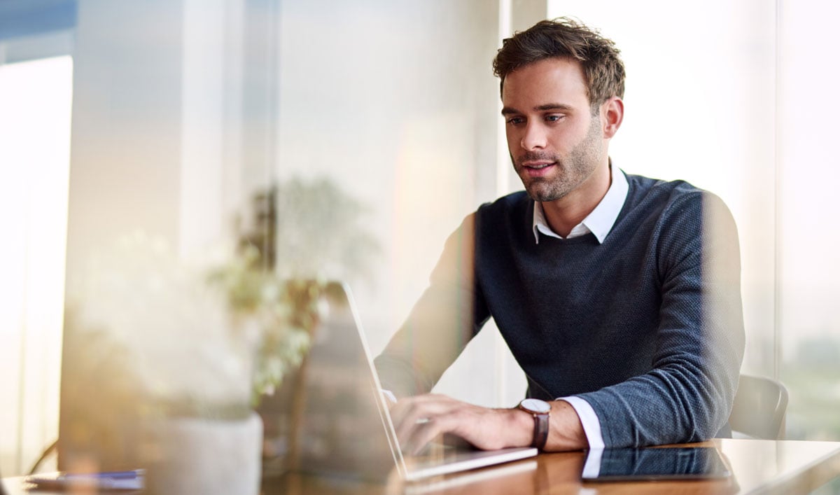 professional male working on laptop in office